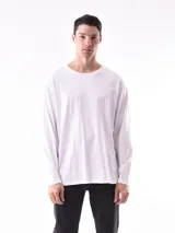 Remera blanca de manga larga, corte holgado y cuello redondo.