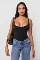 Body negro ajustado al cuerpo, con escote redondo y breteles finos.