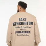 Buzo de cuello redondo en color beige, confeccionado en felpa ligera. Presenta un estampado gráfico en el pecho con la inscripción 'East Kensington Philadelphia' y puños y ruedo acanalados.