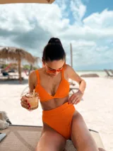 Top de bikini modelo triángulo en color lila, con textura acanalada y breteles regulables. Cuenta con forro interno y cierre mediante atadura en la espalda.