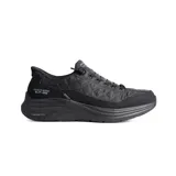 Championes deportivos Skechers modelo Slip-ins Contour Foam, color negro. Presentan un diseño acolchado con textura geométrica en la parte superior, suela de plataforma con tecnología de amortiguación y sistema de ajuste fácil sin cordones tradicionales.