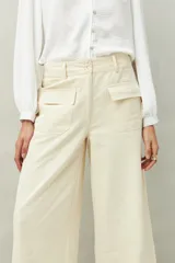 Pantalón wide leg color beige de algodón, con bolsillos delanteros con solapa y cierre con dos botones.