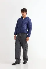 Campera puffer de color azul, con diseño acolchado, cierre frontal completo y capucha integrada. Cuenta con puños elásticos y bolsillos laterales.