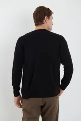 Cardigan de punto con escote en V, cierre frontal con botones y mangas largas. Presenta un diseño clásico con acabado suave al tacto.