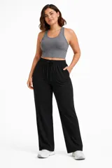 Pantalón deportivo de corte recto y holgado, color negro, con cintura elástica ajustable mediante cordón y bolsillos laterales.