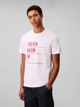 Remera blanca Calvin Klein de corte regular y manga corta, con cuello redondo y estampado gráfico de inspiración urbana en el pecho.