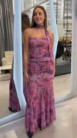 Vestido largo strapless de tul con estampado tie-dye en tonos rosado y violeta, con fruncidos laterales y pañuelo del mismo género para el cuello.