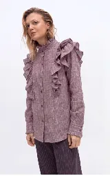 Camisa de algodón color lila con efecto melange, cuello alto con volados, cierre frontal con botones y amplios volados decorativos en los hombros y el delantero. Cuenta con mangas largas y puños con botones y volados.