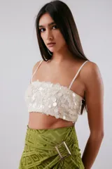 Top corto color blanco con lentejuelas y tirantes finos.