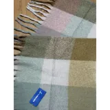 Bufanda rectangular de tejido grueso con diseño de cuadros en tonos azul, naranja, gris y beige, terminada con flecos en los extremos.