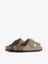 Sandalias Birkenstock Arizona SFB de cuero color topo, con plantilla anatómica de corcho y látex cubierta de ante. Ajuste con dos hebillas metálicas color cobre.