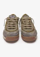 Championes Satorisan modelo Enso Suede, color verde musgo, confeccionados en gamuza con detalles de costuras y parche lateral con logo. Presentan suela de goma en tono caramelo y cordones al tono.