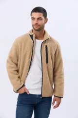 Campera de corderito con interior de polar, cuello alto y cierre frontal. Presenta un bolsillo vertical con cierre en el pecho, bolsillos laterales y detalles de ribete en contraste.