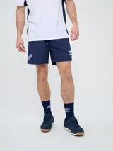 Short de baño de secado rápido, color azul, con cordón ajustable en la cintura, bolsillos laterales y el escudo del Club Nacional de Football junto al logo de Umbro bordados en las piernas.