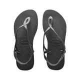 Ojotas Havaianas modelo Luna, color negro con tiras finas plateadas y ajuste al tobillo.