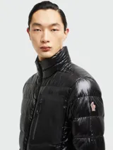 Campera puffer negra Moncler modelo Fraser, con cierre frontal y bolsillos laterales con cierre. Presenta un bolsillo con cierre en el pecho y logo de la marca en la manga izquierda.