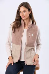 Chaleco de sherpa combinado en tonos beige, con cuello alto y cierre frontal. Presenta una textura suave y abrigada, ideal para capas adicionales.