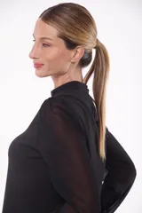 Blusa negra con cuello mao y abertura en forma de gota en el escote. Mangas largas abullonadas de gasa transparente con puños elásticos.