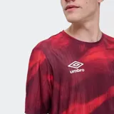 Remera deportiva Umbro modelo Press, de color rojo con un estampado abstracto en tonos más oscuros, cuello redondo y manga corta. Incluye el logo de la marca en el pecho y el escudo del Club Nacional de Football.