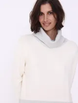 Sweater blanco con cuello alto y puños en color gris.