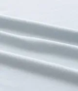 Remera deportiva de hombre con tecnología dry fit, cuello redondo y manga corta. Presenta un diseño liso en color beige con una pequeña etiqueta decorativa en el dobladillo.