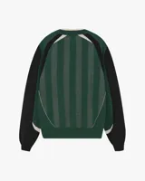 Suéter de punto Nude Project con diseño inspirado en camisetas de fútbol retro. Presenta un patrón de rayas verticales en tonos verde, negro y gris, con el logo de la marca en gran tamaño y una rosa bordada en el pecho. Posee cuello redondo acanalado y mangas largas con puños elásticos.