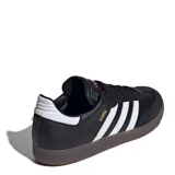 Championes Adidas Samba de mujer, color negro con las tres franjas características en plateado, puntera de ante y suela de goma translúcida.