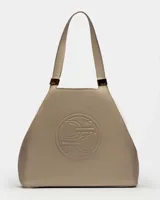 Bolso de hombro azul marino de cuero graneado con logo grabado en el centro.