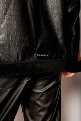 Campera negra con paneles de cuero sintético con textura de cocodrilo, corderito color crema en la parte superior y detalles en cuero marrón.