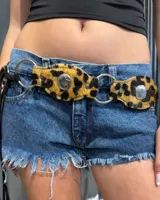 Cinturón de cuero con pelo estampado animal print, compuesto por piezas unidas mediante argollas metálicas plateadas y decorado con apliques metálicos en forma de estrella.