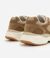 Championes deportivos para hombre marca Renner en color verde militar, confeccionados con capellada de poliuretano y poliéster con detalles texturizados. Presentan diseño de recortes superpuestos, cierre con cordones, entresuela volumosa en tono blanco y beige, y suela de goma.