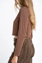 Polera de manga larga color marrón jaspeado, con cuello alto y corte ajustado al cuerpo.