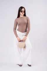 Body de mangas largas en color beige, con cuello elevado y diseño ajustado al cuerpo.