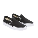 Zapatillas Vans Classic Slip-On negras con suela blanca de goma y logo de la marca en el lateral.