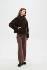 Tapado de textura tipo corderito en color marrón, con cuello solapa y cierre frontal de botones.