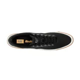 Sneakers Caterpillar modelo Amp Canvas, de color negro con suela de plataforma blanca y base de goma marrón. Capellada de lona con detalles de poliuretano, cordones negros y ojalillos metálicos. Presenta la inscripción de la marca en la lengüeta y en el lateral del talón.