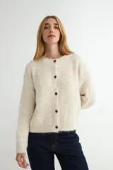 Cardigan de tejido de punto jaspeado en tonos rosados y violetas, con cuello redondo y cierre frontal de botones marrones.