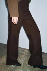 Jeans de tiro alto con corte wide leg y largo completo. Presenta diseño de cinco bolsillos, trabillas en la cintura y cierre frontal con cremallera y botón, con un acabado de efecto lavado.