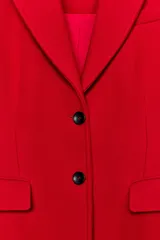 Abrigo largo de Zara confeccionado en mezcla de lana color rojo, con cuello de solapa, manga larga, bolsillos con solapa en el frente y cierre frontal de botones negros.