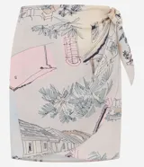 Pollera recta corta de viscosa en color beige con estampado de paisajes y palmeras, con lazo lateral ajustable en la cintura.