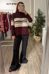 Sweater de punto con cuello alto, manga larga y puños acanalados. Presenta un diseño de franjas horizontales en tonos crema, rosa y verde sobre una base color bordó.