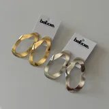 Par de aros colgantes con forma ovalada irregular, disponibles en plateado y dorado.