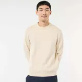 Sweater de punto de cuello redondo, manga larga y diseño liso, con puños y ruedo acanalados.