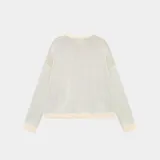 Sweater de punto color beige con cuello redondo y logo 'EME STUDIOS curated by ben ice' estampado en marrón en el frente.