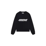 Buzo de cuello redondo negro, corte oversized de manga larga con estampa tipográfica frontal en blanco que dice "EMEME" y la frase "LISTEN TO YOUR FEELINGS, FEEL THE YOUTH".