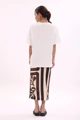 Remera blanca de manga corta, corte oversize, con estampa colorida de motivos marinos y botánicos en el frente.
