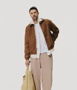Pantalón baggy masculino de corte holgado, color beige, confeccionado en algodón con felpa. Posee cintura elástica con cordón ajustable, bolsillos delanteros y bajo con regulador por elástico.