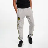 Pantalón de jogging negro con puños elásticos, cordón ajustable en la cintura, escudo del Club Atlético Peñarol bordado en amarillo y franjas laterales amarillas y grises.