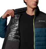 Campera puffer Columbia modelo Powder Lite II, diseño en bloque de color con la parte superior negra y la inferior en verde oscuro, con cierre frontal y detalles en verde lima brillante.