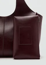 Bolso tipo tote color bordó, de diseño estructurado, con correa para el hombro y solapa frontal.